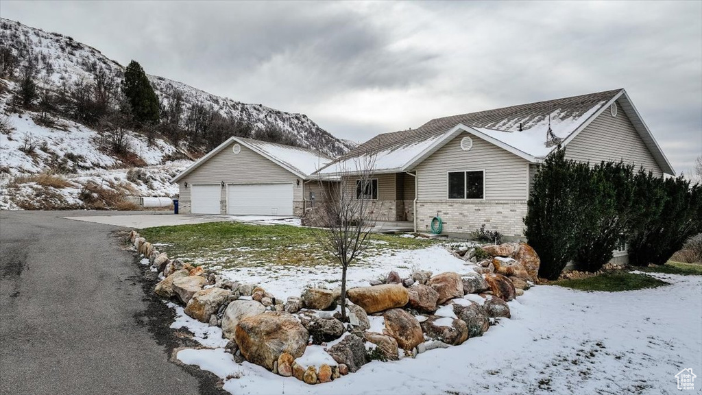 View of front of property featuring a garage and a mountain view