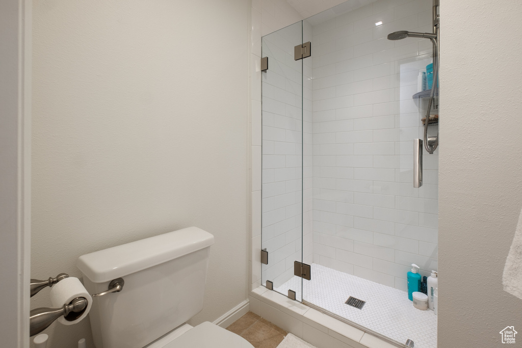 Bathroom with toilet and a shower with shower door