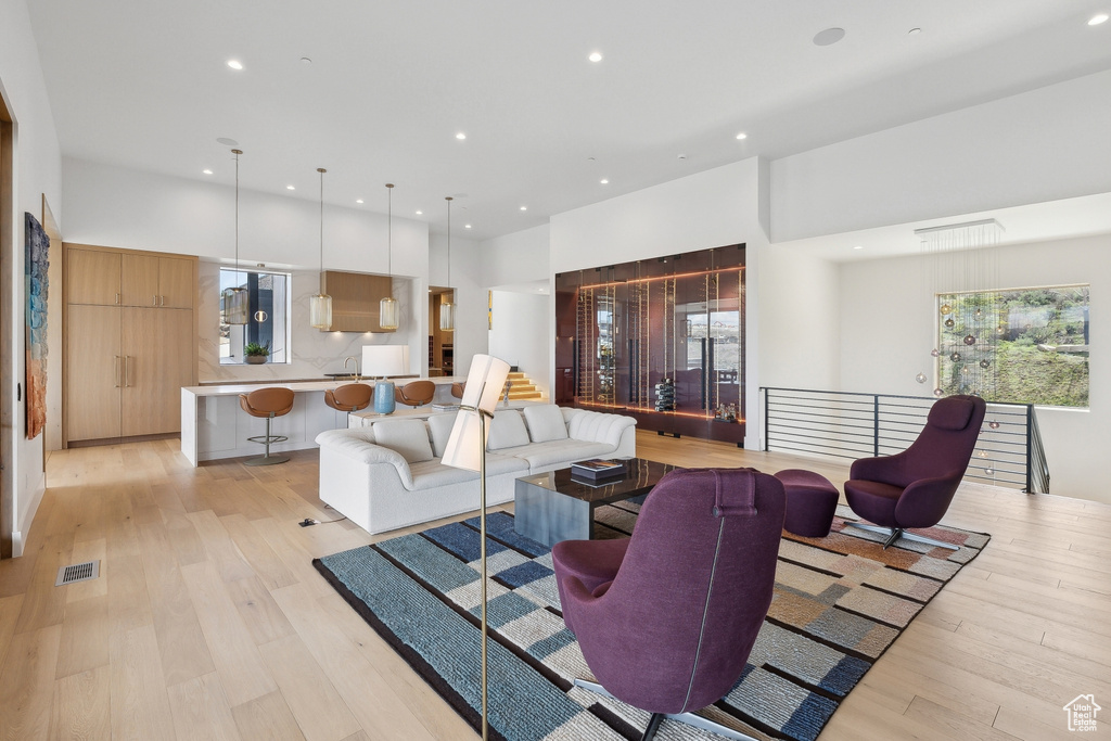 Living area with recessed lighting, light wood-style floors, and healthy amount of natural light