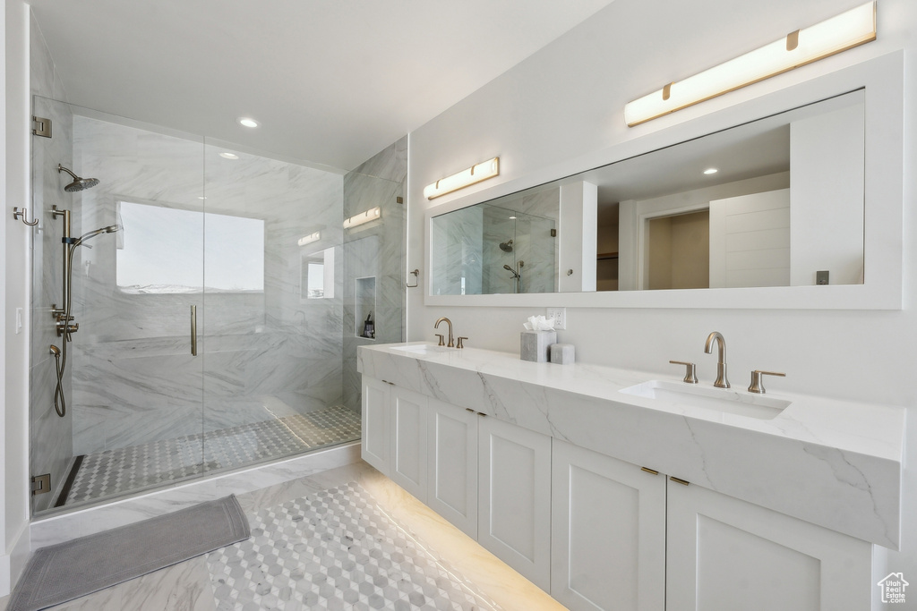 Bathroom with a shower with door and vanity