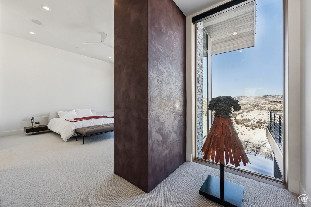 Carpeted bedroom featuring expansive windows
