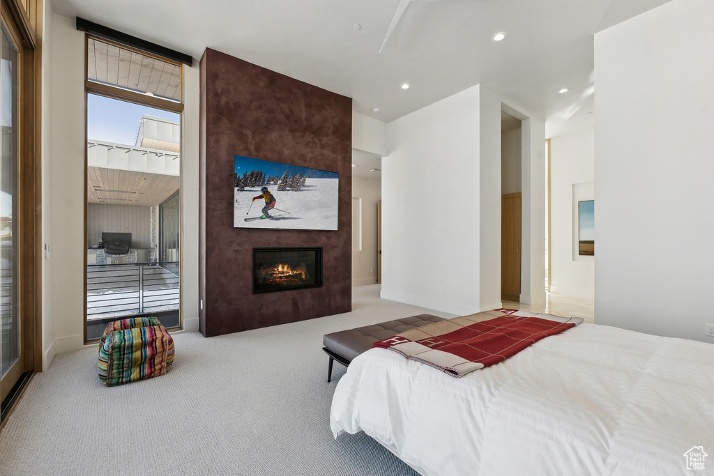 Carpeted bedroom with a large fireplace