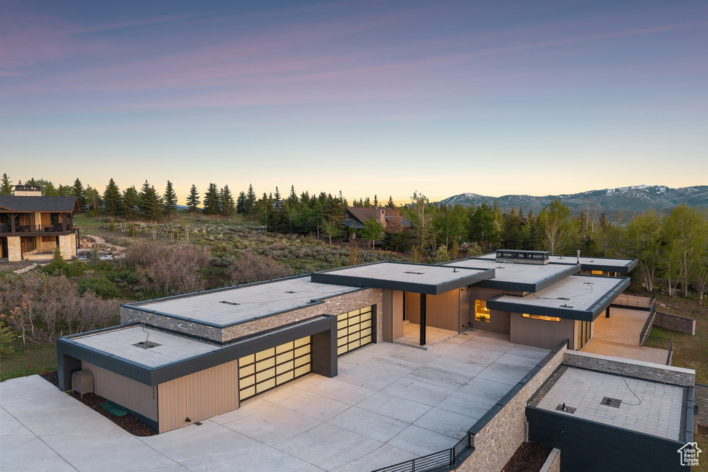 View of front of property with driveway and a mountain view