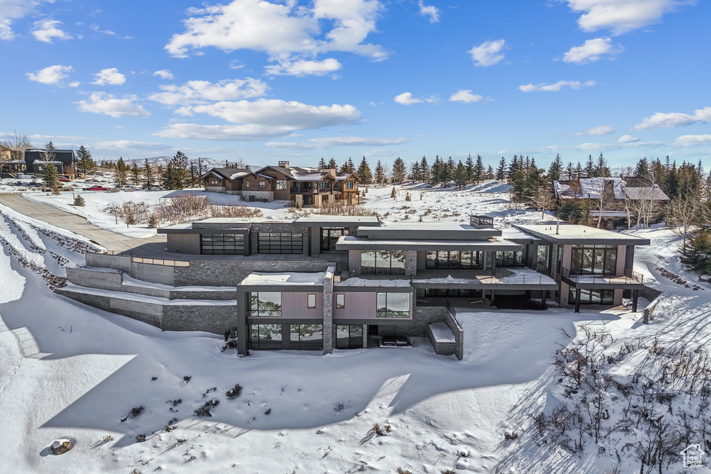 View of snow covered rear of property