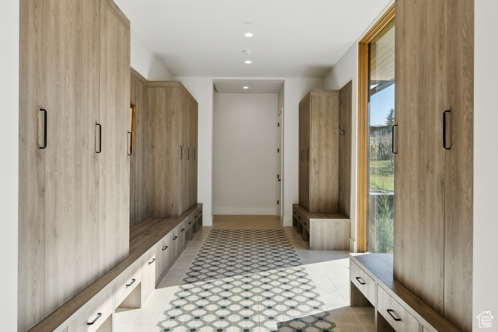 Mudroom with light tile patterned floors, recessed lighting, and baseboards