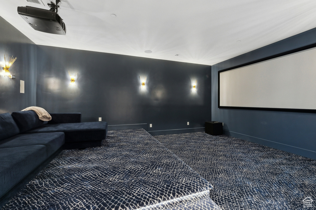 Carpeted home theater room featuring baseboards