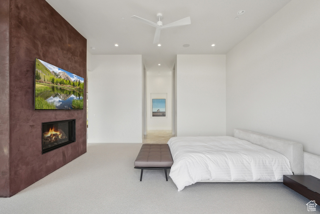 Bedroom featuring carpet flooring, a glass covered fireplace, recessed lighting, and ceiling fan