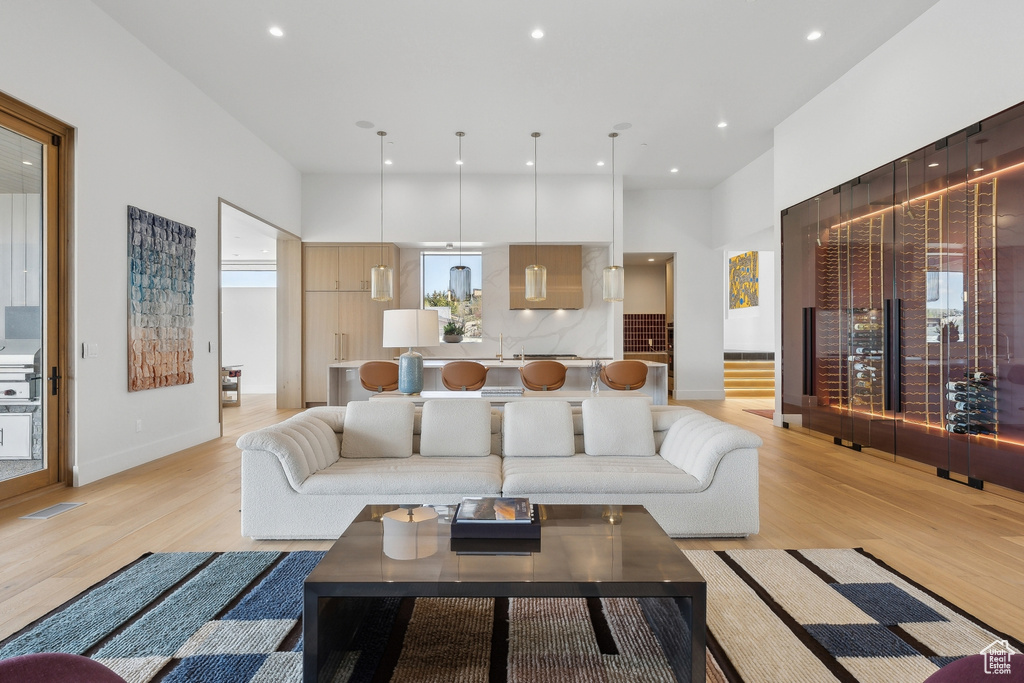 Living room featuring light wood-style floors, recessed lighting, and baseboards