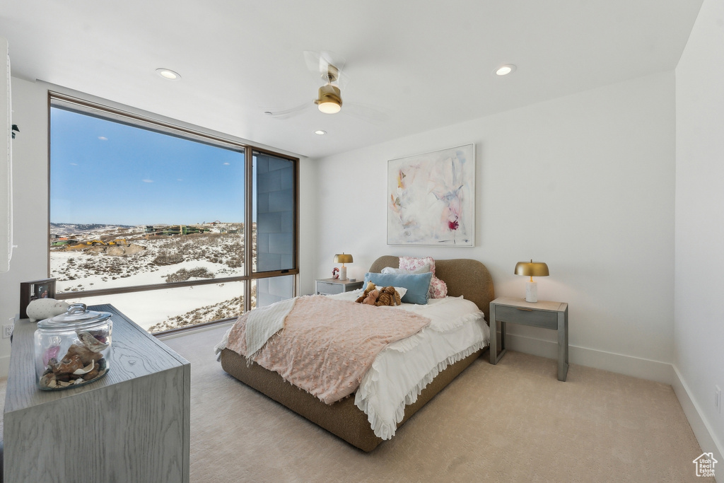 Carpeted bedroom featuring ceiling fan