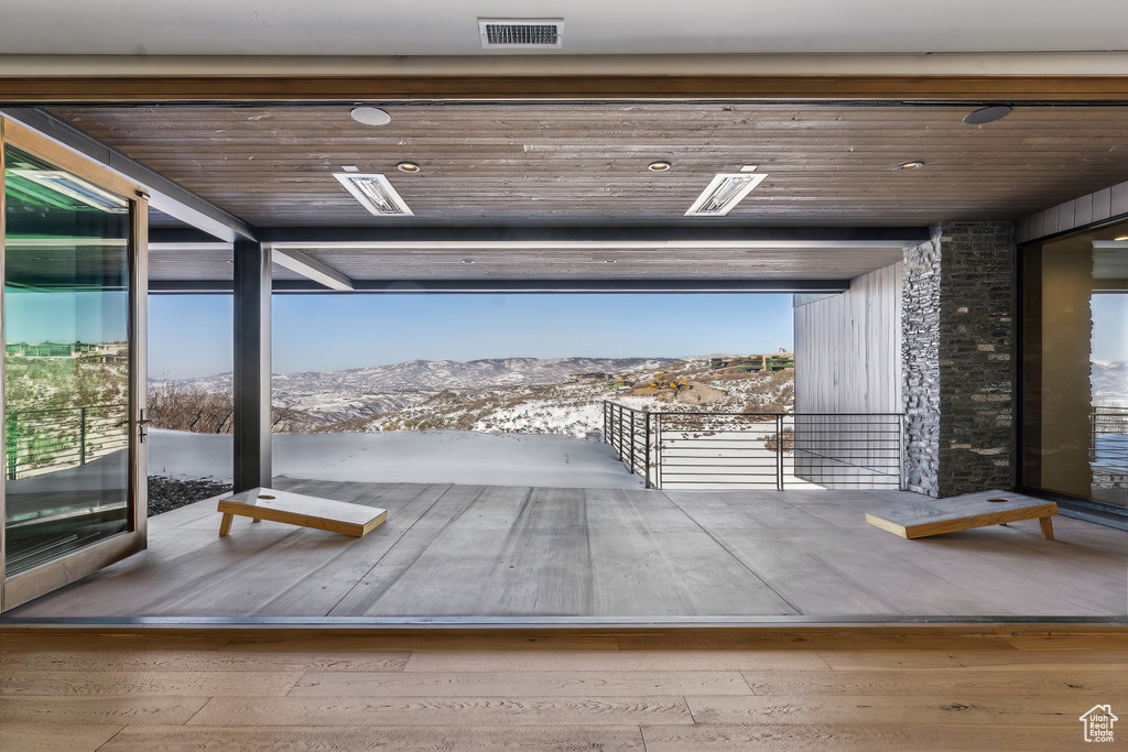 Entryway featuring a mountain view, wood ceiling, and wood-type flooring