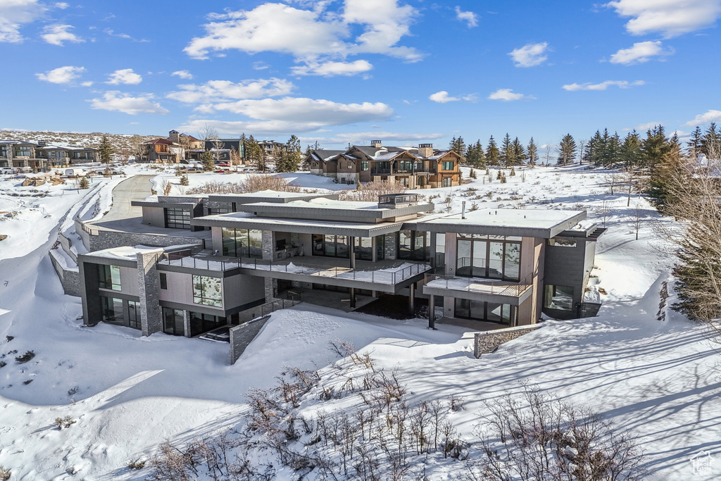 View of snow covered rear of property