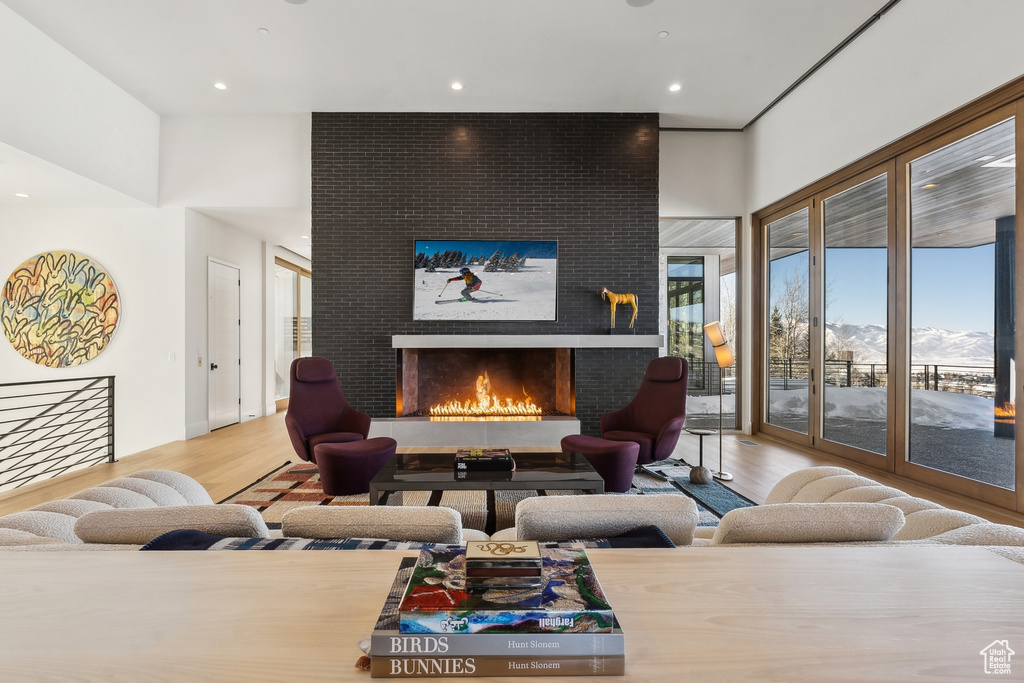 Living room with a mountain view, a large fireplace, and hardwood / wood-style floors