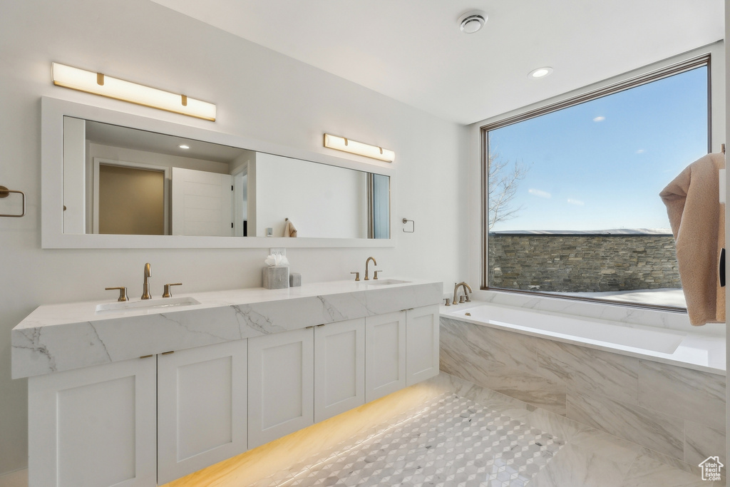 Bathroom with a relaxing tiled tub and vanity