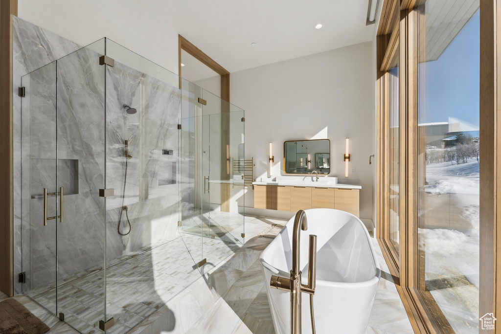 Bathroom with vanity and separate shower and tub