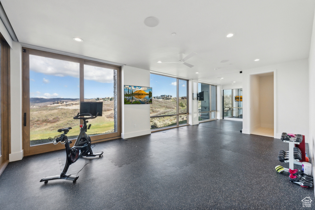 Workout area featuring plenty of natural light, a ceiling fan, expansive windows, and recessed lighting