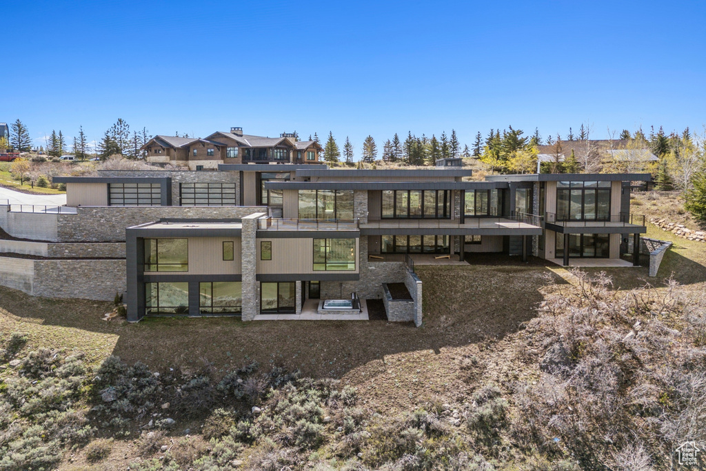 Rear view of house featuring a patio area and a residential view