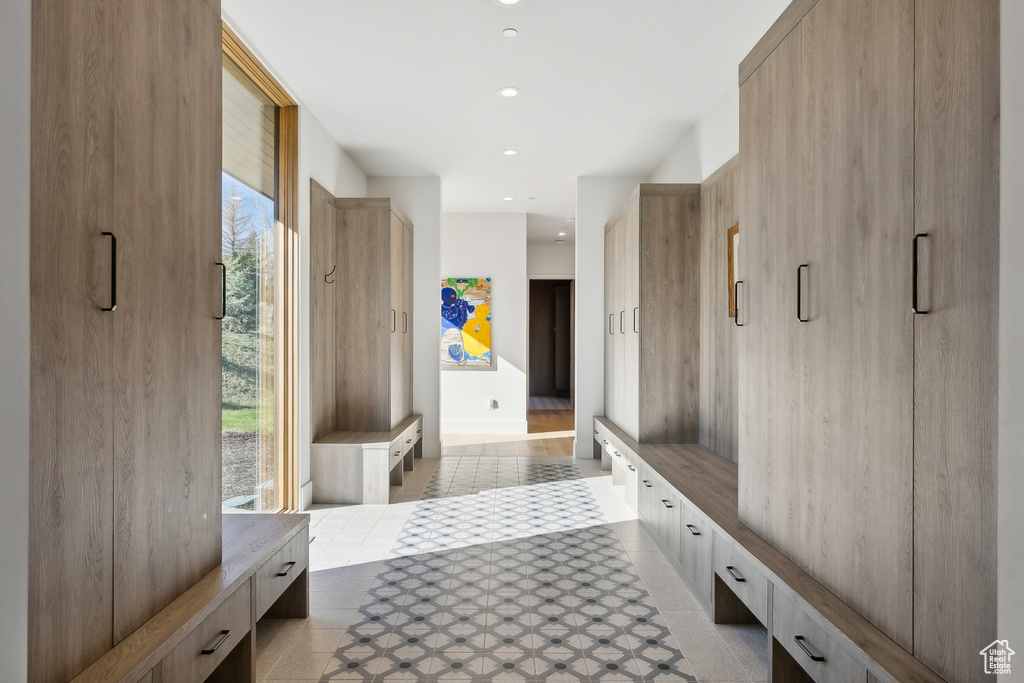 Mudroom with light tile patterned floors and recessed lighting