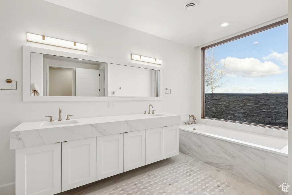 Bathroom with double vanity and a garden tub