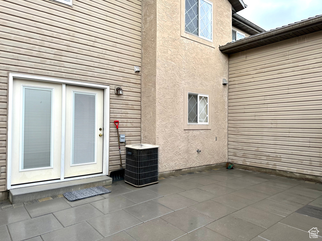 Doorway to property with a patio, french doors, and central air condition unit