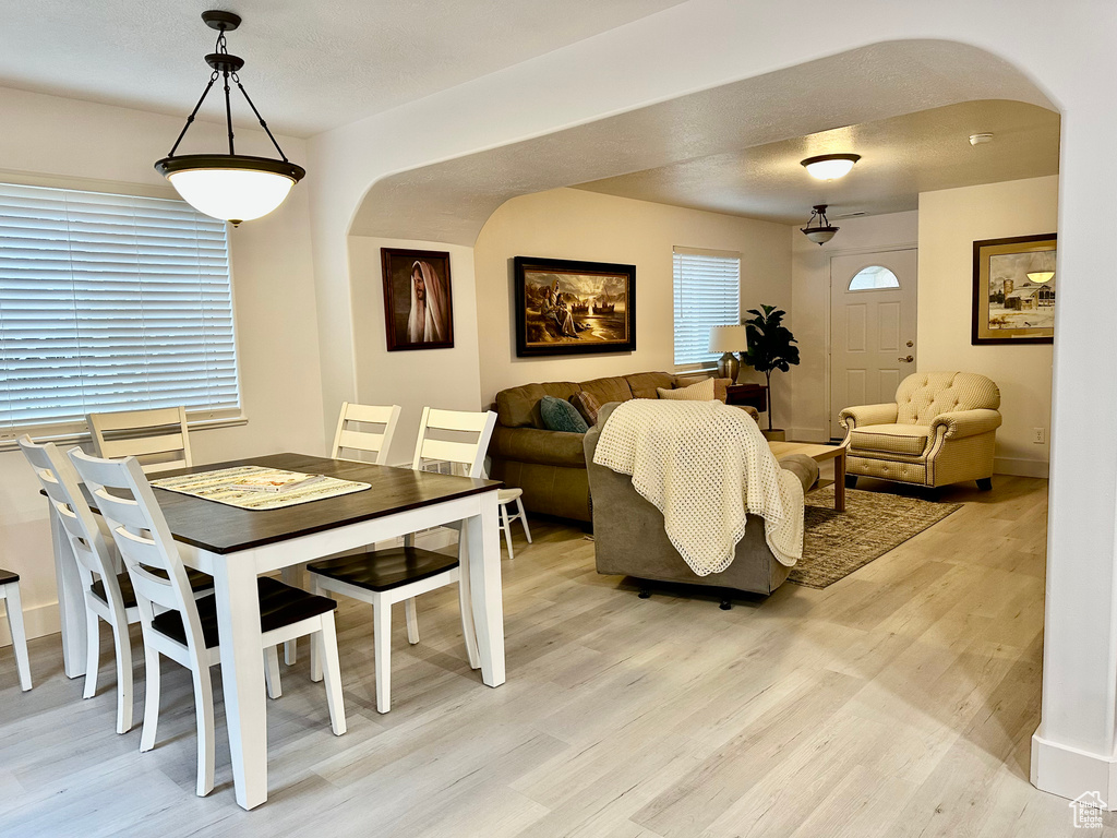 Dining space with light hardwood / wood-style floors