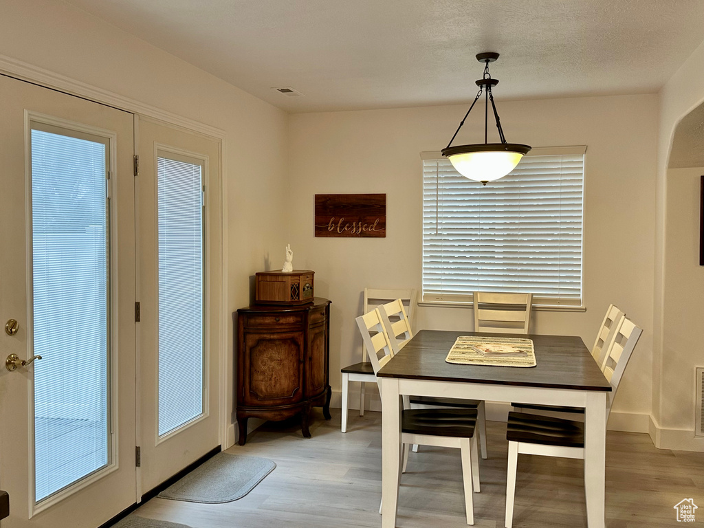 Dining space with light wood-type flooring