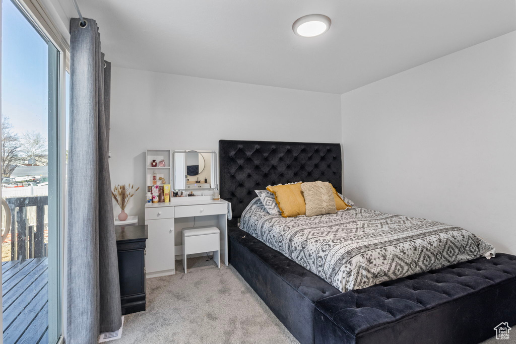 Bedroom featuring light carpet