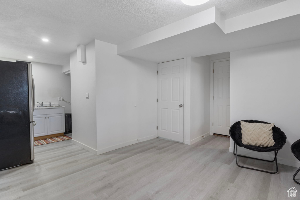 Sitting room featuring light hardwood / wood-style floors and a textured ceiling