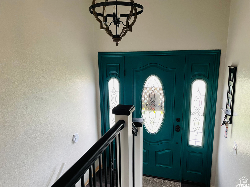 Entryway with a notable chandelier and a wealth of natural light