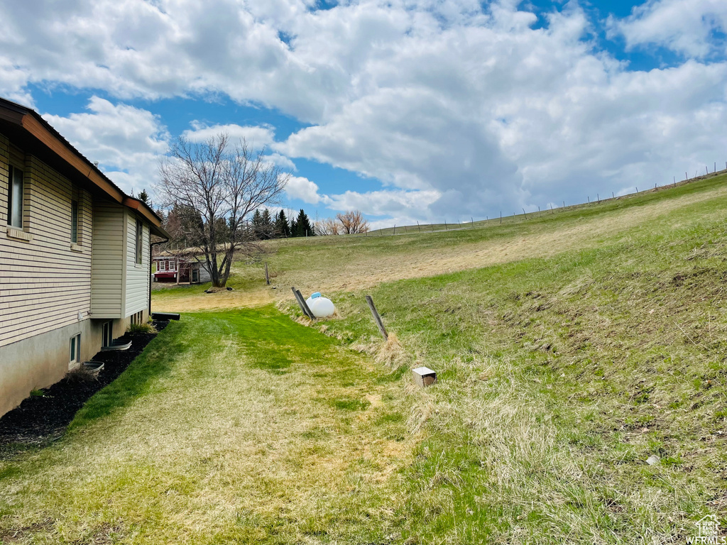 View of yard with a rural view