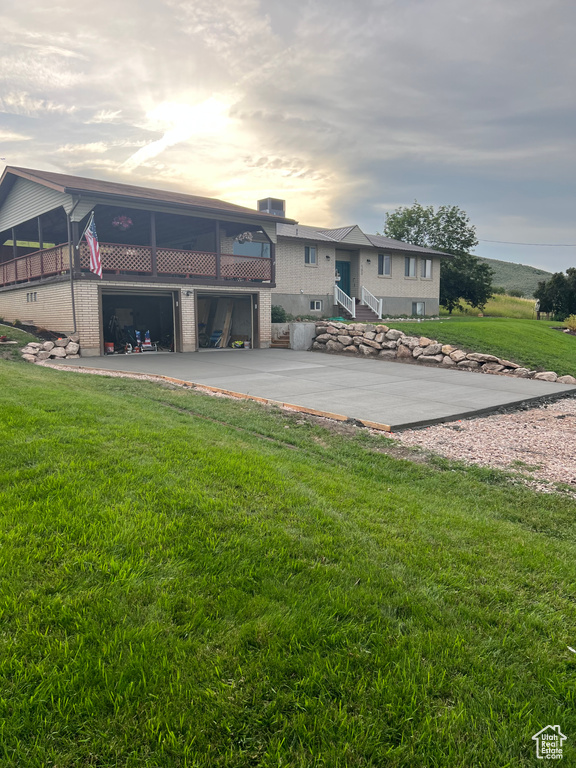 View of front of house with a garage and a lawn