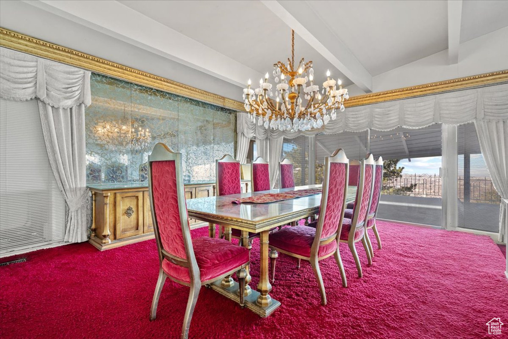 Carpeted dining room with an inviting chandelier and lofted ceiling with beams