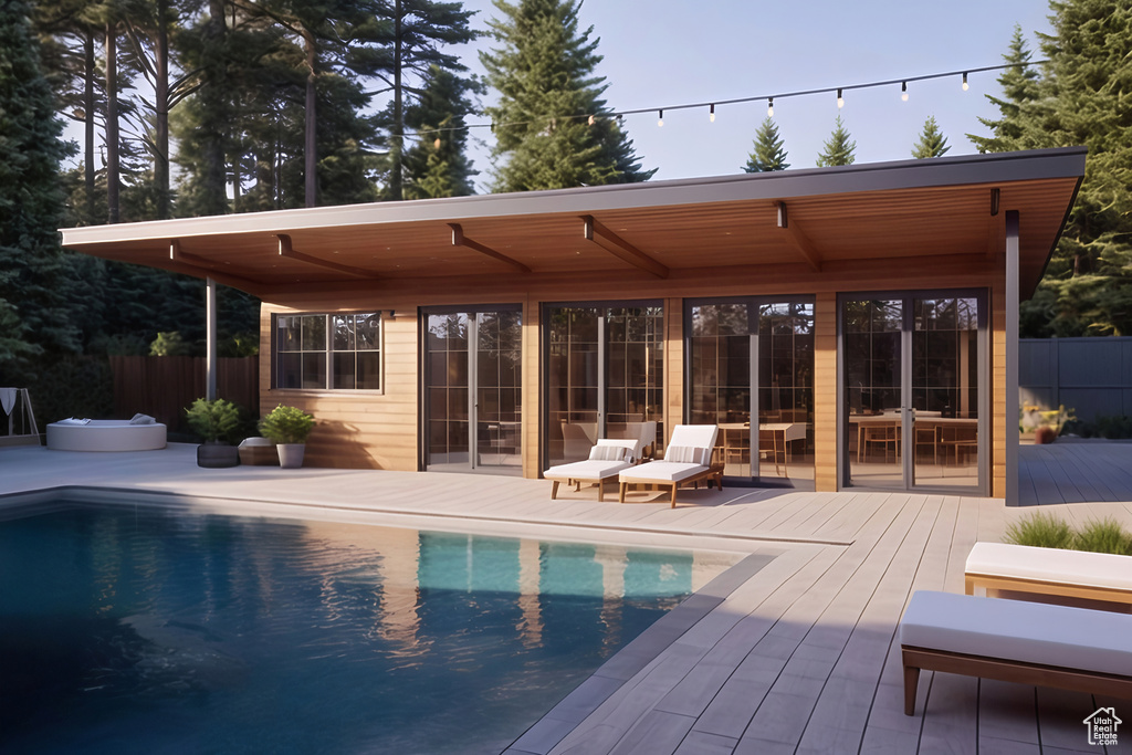 View of pool featuring a wooden deck