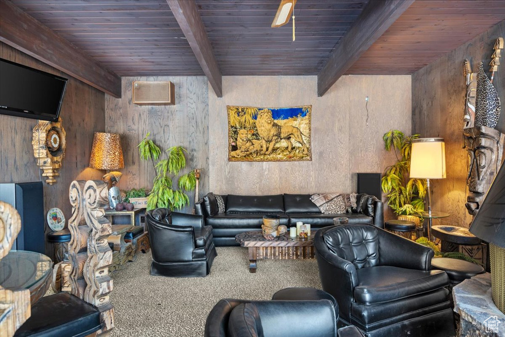 Carpeted living room featuring beam ceiling and wooden ceiling