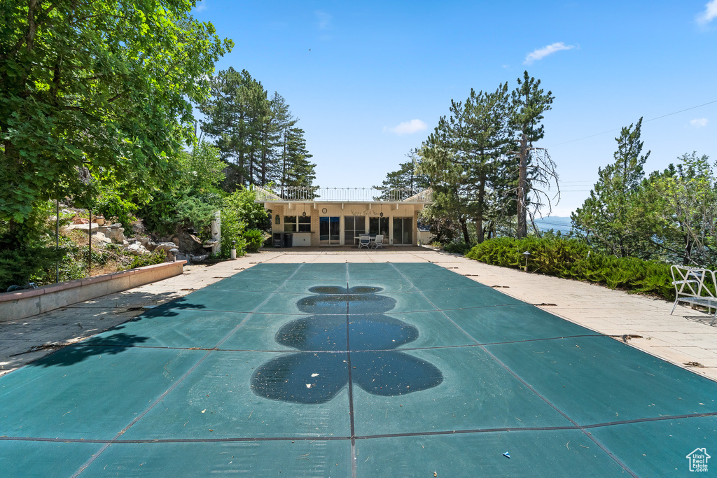 View of pool featuring a covered pool and a patio