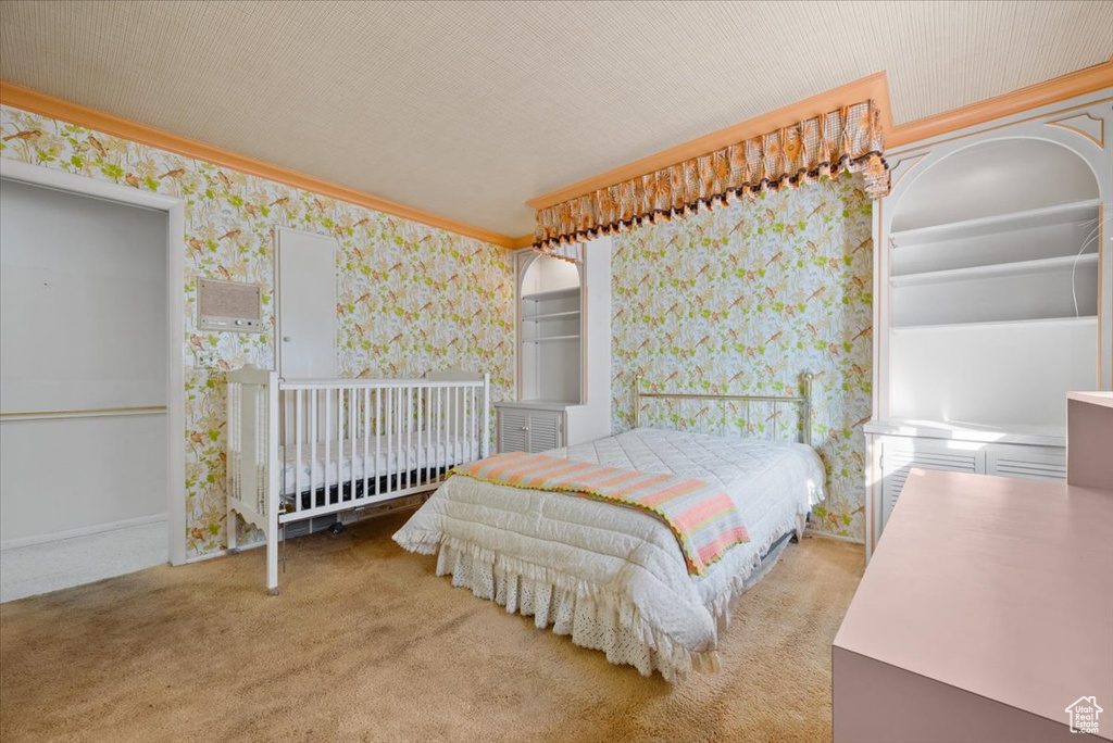 Carpeted bedroom with ornamental molding