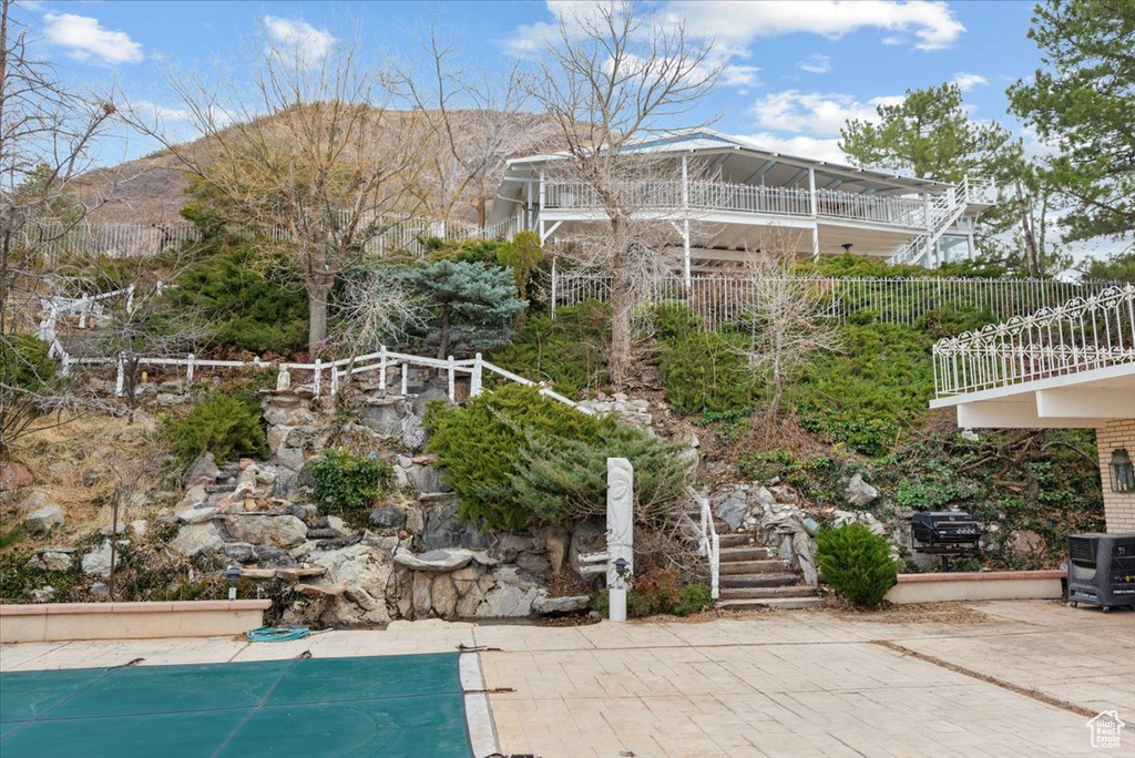 View of swimming pool featuring a mountain view and a patio