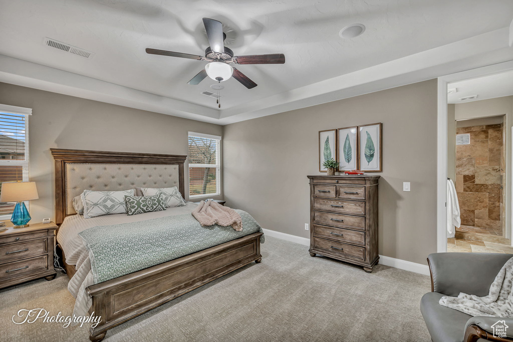 Carpeted bedroom with ceiling fan