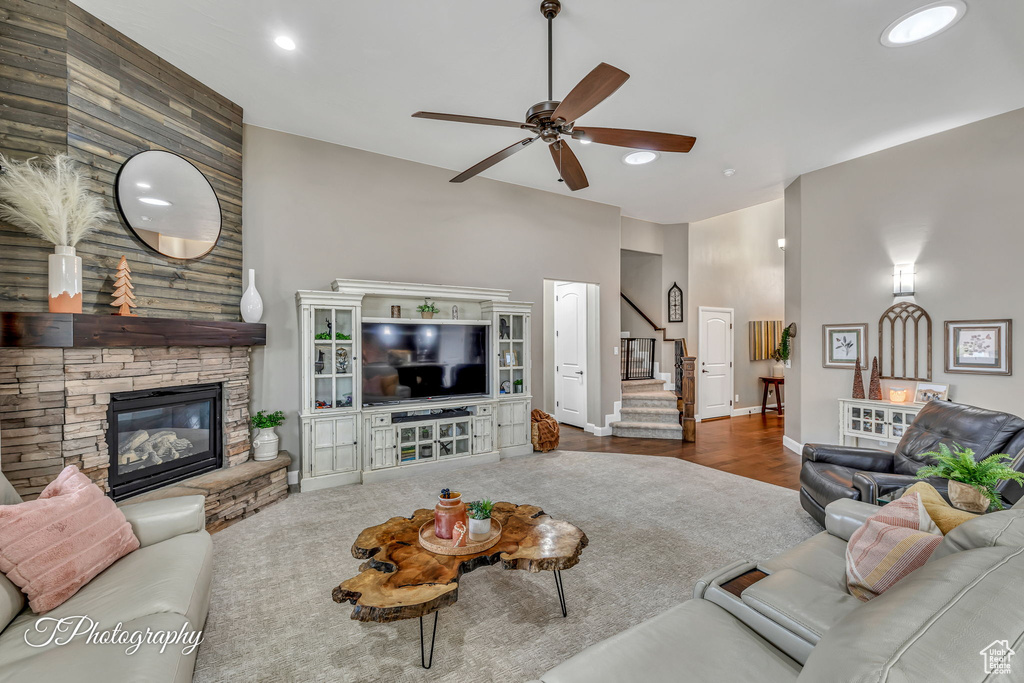 Living room featuring ceiling fan and a fireplace