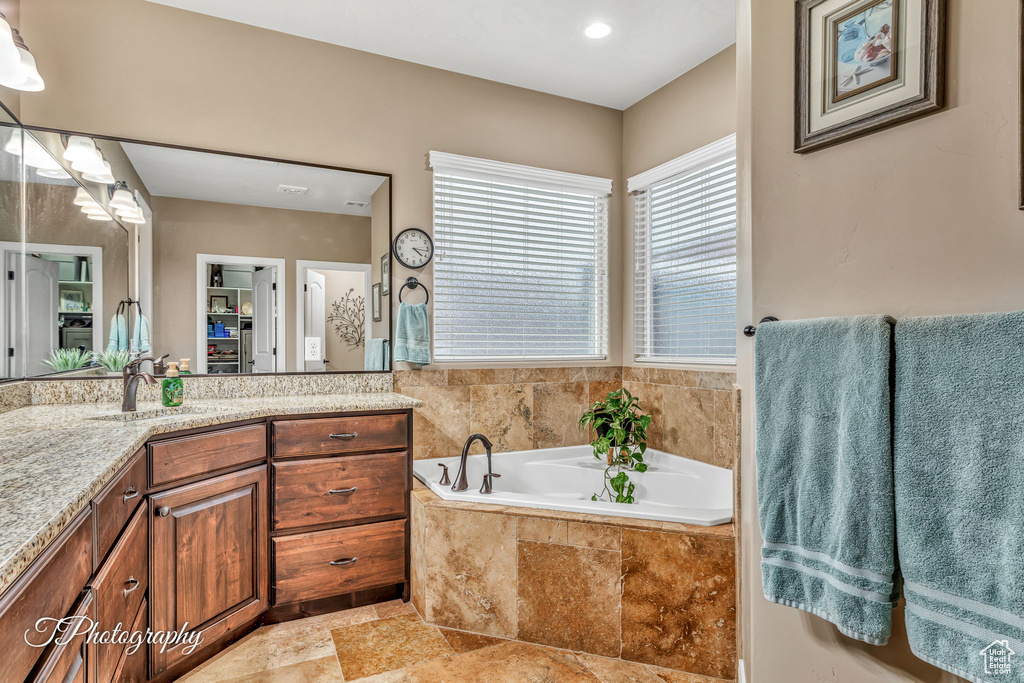 Bathroom with vanity and a relaxing tiled tub