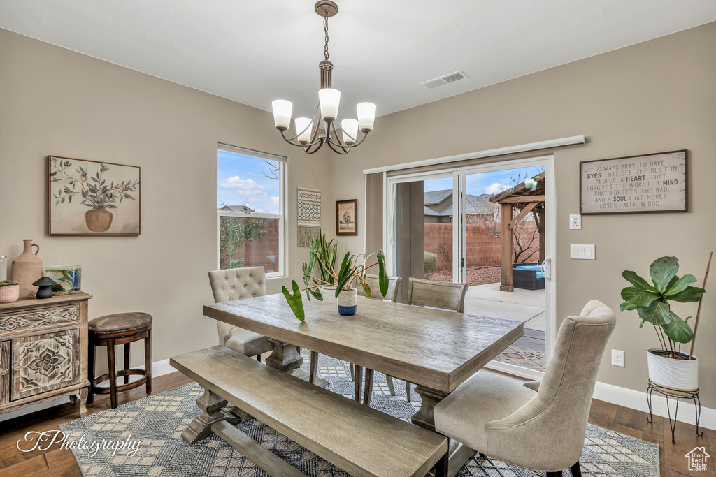 Dining area featuring hardwood / wood-style floors and a notable chandelier