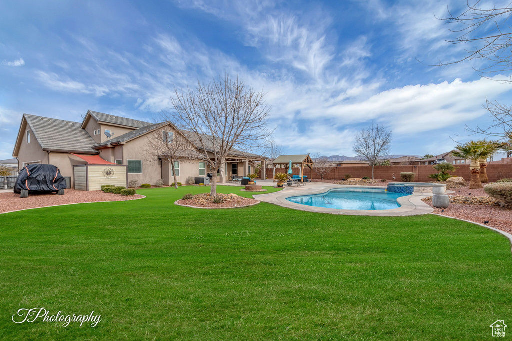 View of swimming pool featuring a yard