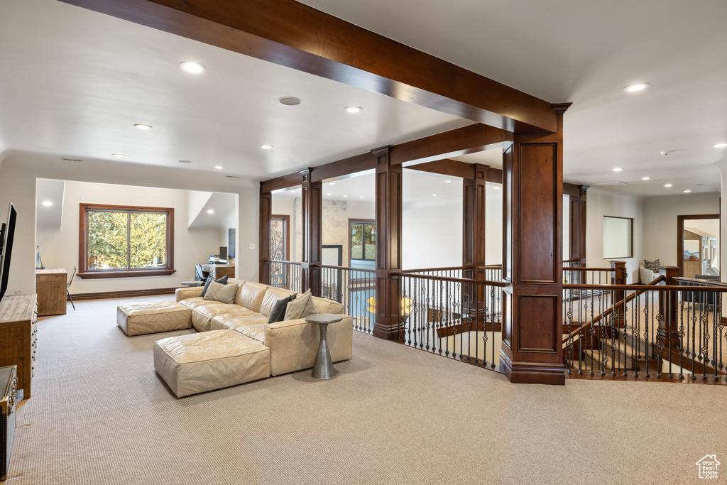 Living room featuring carpet, recessed lighting, and decorative columns