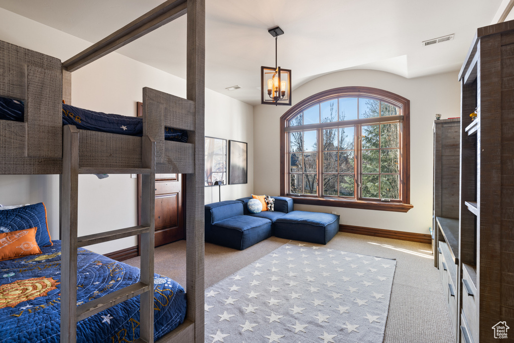 Bedroom featuring carpet and a chandelier