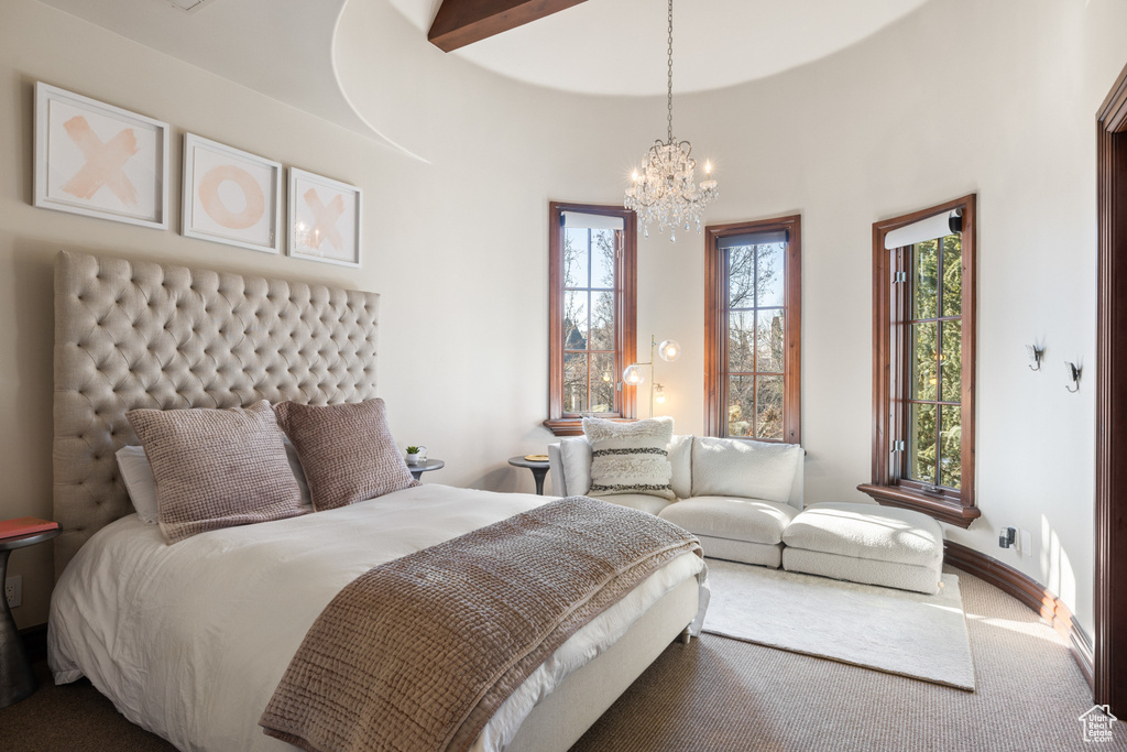 Bedroom with a chandelier, multiple windows, and carpet