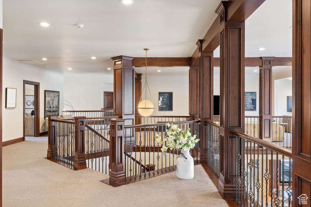 Hall with an upstairs landing, carpet flooring, and recessed lighting