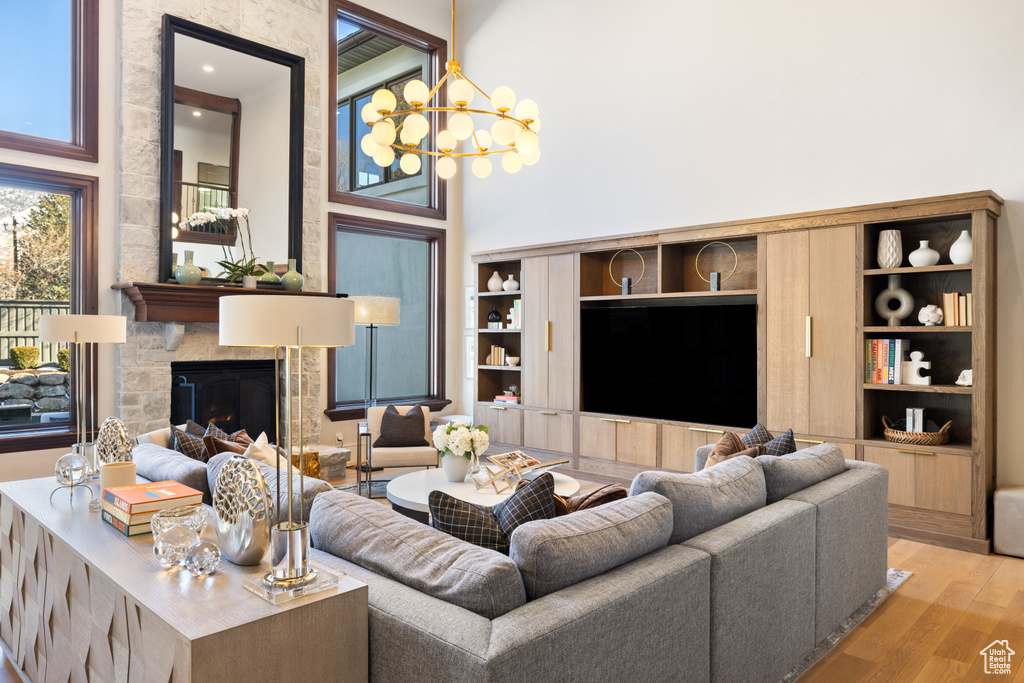 Living area featuring wood finished floors, a chandelier, and a fireplace