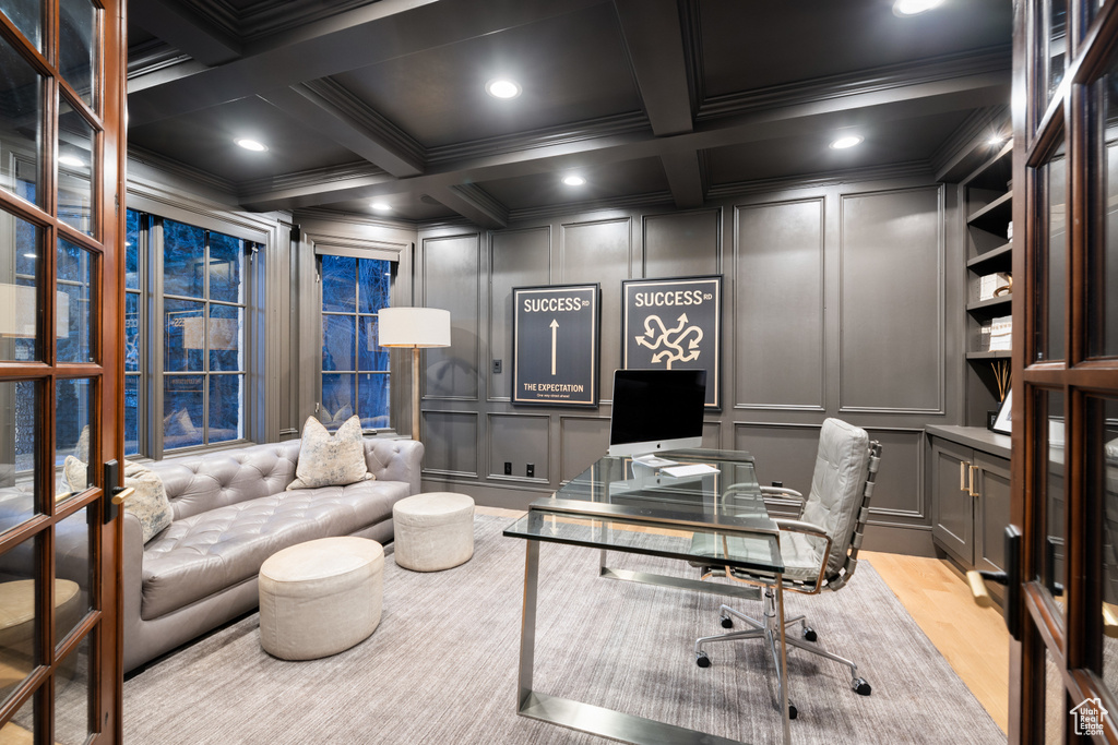 Office area featuring a decorative wall, crown molding, coffered ceiling, beam ceiling, and wood finished floors