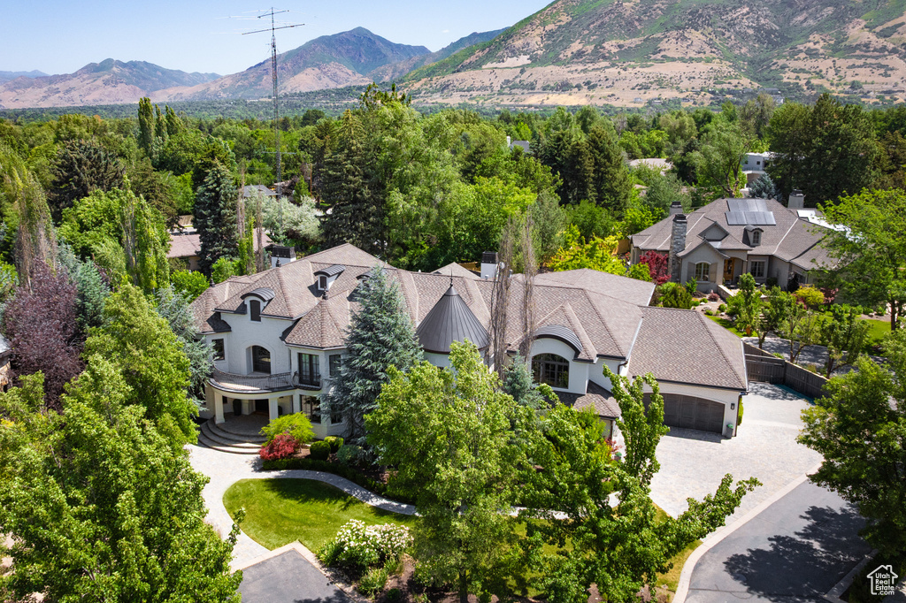 Aerial view of property and surrounding area with a mountainous background