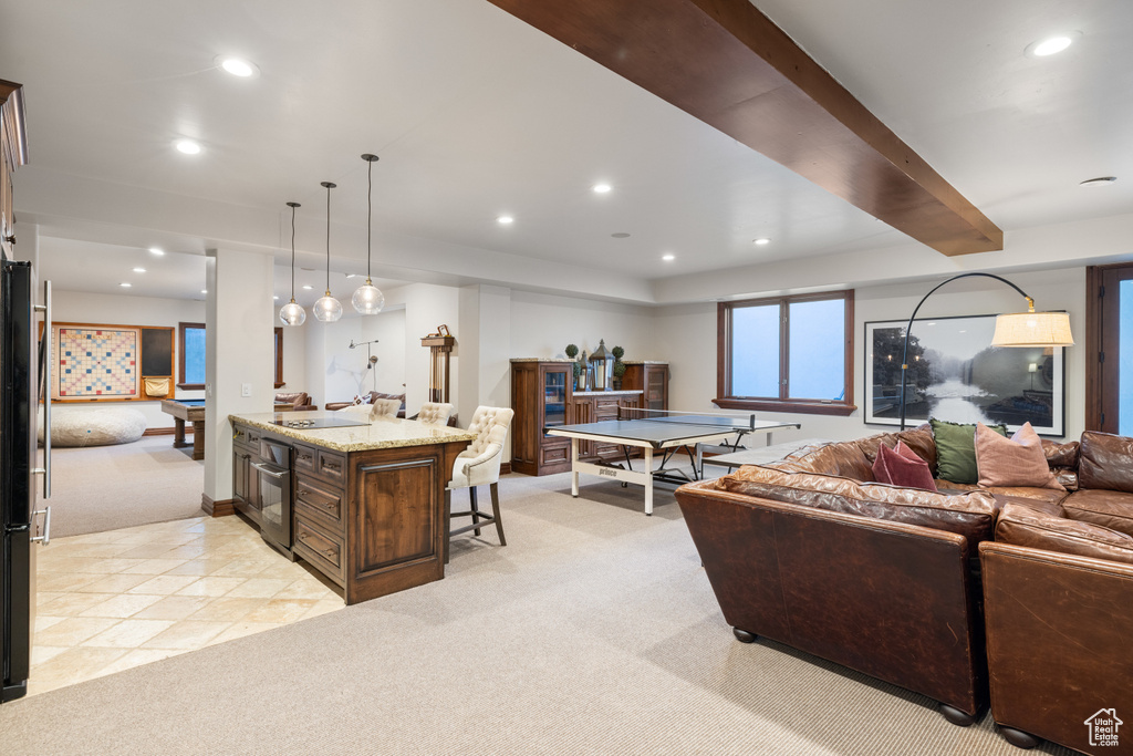 Living area with light carpet, recessed lighting, and bar area