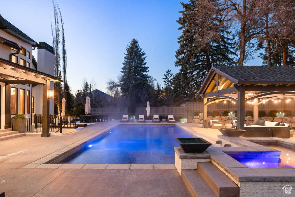View of swimming pool featuring an in-ground hot tub, a gazebo, a patio area, a fenced backyard, and outdoor lounge area